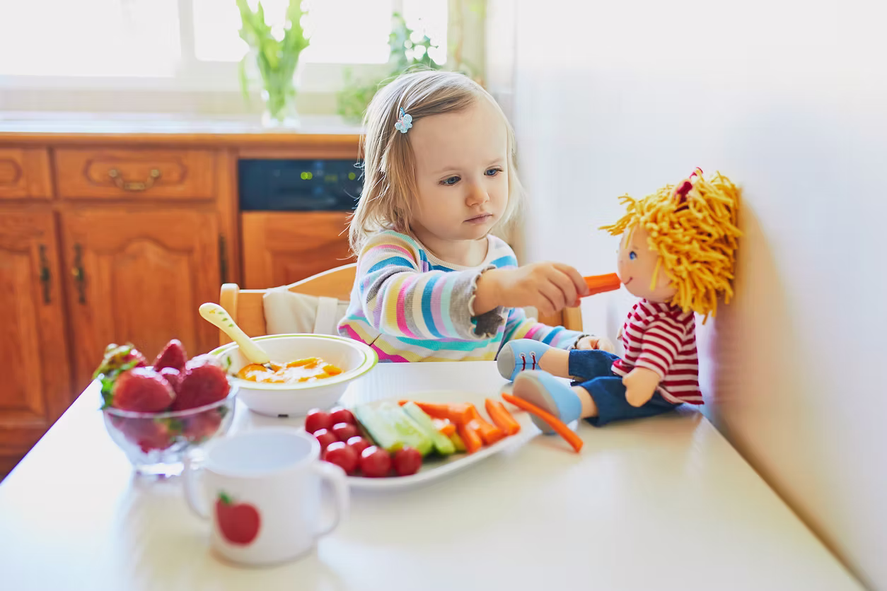 Child exploring new foods through play during feeding therapy
